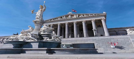 Austrian Parliament Building in Vienna with its columned façade and Pallas Athena Fountain