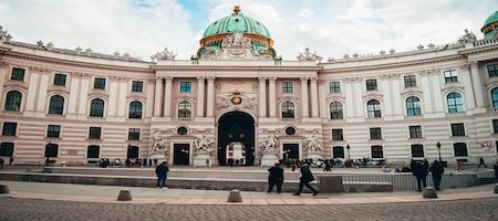 Hofburg Palace’s curved façade and green dome at Michaelerplatz in Vienna