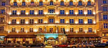 Hotel Sacher Vienna with its illuminated façade and entrance at night