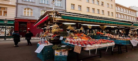 Fruit and vegetable stall under green awnings at Vienna’s Naschmarkt