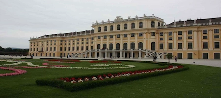 Schönbrunn Palace with colourful flowerbeds and formal lawns in Vienna