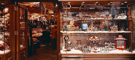 Souvenir shop window filled with miniature Christmas villages and festive decorations
