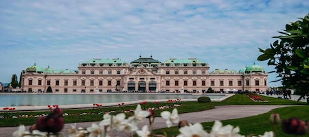 Upper Belvedere Palace with a reflecting pool and flowerbeds in Vienna