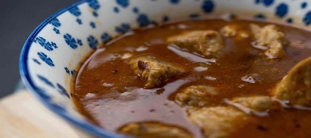 Wiener Saftgulasch served in a blue and white patterned bowl